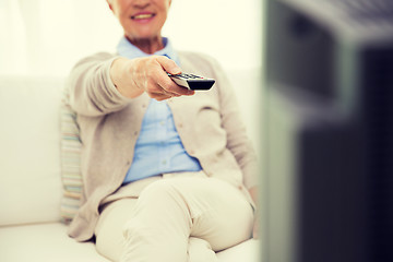 Image showing close up of happy senior woman watching tv at home