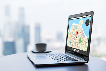 Image showing close up of laptop and coffee cup on office table