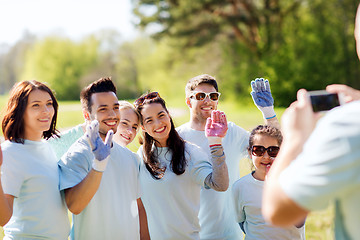 Image showing group of volunteers taking picture by smartphone