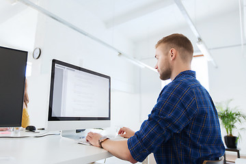 Image showing creative man or programmer with computer at office