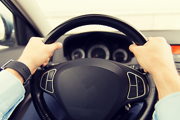 Image showing close up of young man driving car