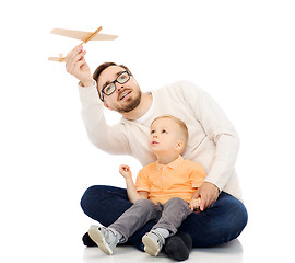 Image showing father and little son playing with toy airplane