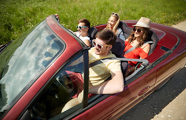 Image showing happy friends driving in cabriolet car