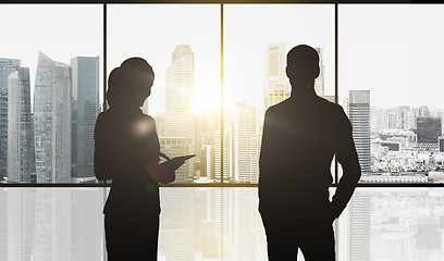 Image showing silhouettes of business partners over city office