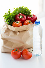 Image showing close up of paper bag with vegetables and water