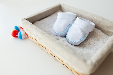 Image showing close up of baby bootees for newborn boy in basket