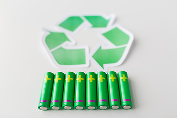 Image showing close up of batteries and green recycling symbol