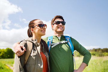 Image showing happy couple with backpacks hiking outdoors