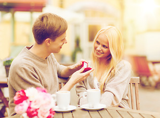 Image showing romantic man proposing to beautiful woman