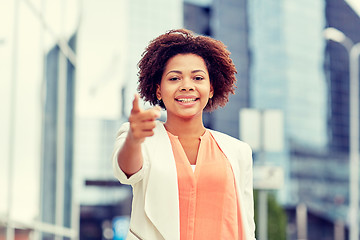 Image showing happy african businesswoman pointing finger on you