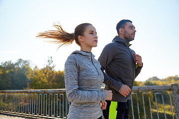 Image showing happy couple running outdoors