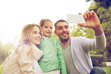 Image showing happy family taking selfie by smartphone outdoors