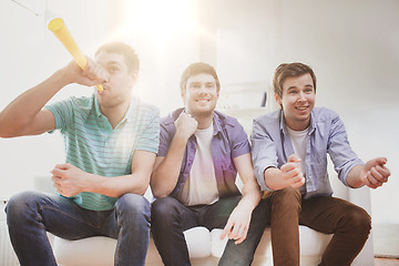 Image showing happy male friends with vuvuzela