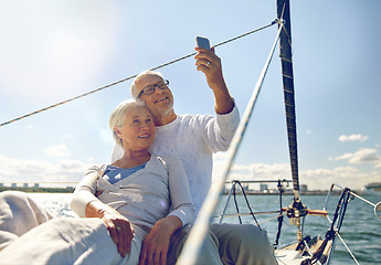 Image showing senior couple taking selfie by smartphone on yacht