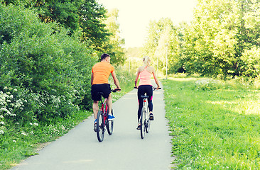 Image showing happy couple riding bicycle outdoors