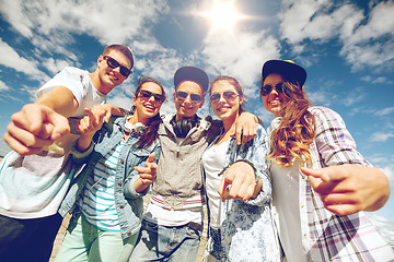 Image showing smiling teenagers in sunglasses hanging outside