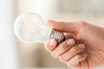 Image showing close up of hand holding edison lamp or lightbulb