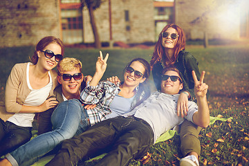 Image showing group of happy students showing victory gesture