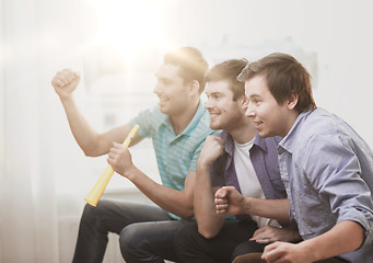 Image showing happy male friends with vuvuzela watching sports