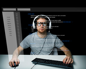 Image showing man in headset hacking computer or programming