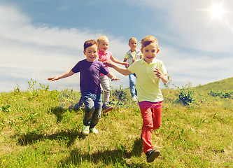 Image showing group of happy kids running outdoors