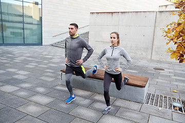 Image showing couple doing lunge exercise on city street