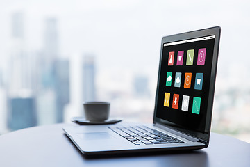 Image showing close up of laptop and coffee cup on office table