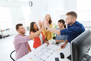 Image showing creative team making high five at office