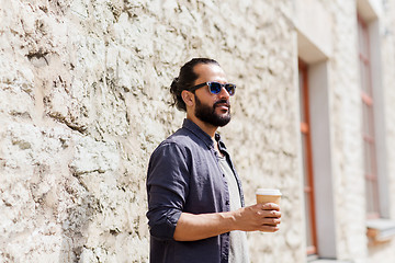 Image showing man drinking coffee from paper cup on street