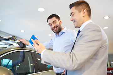 Image showing happy man with car dealer in auto show or salon