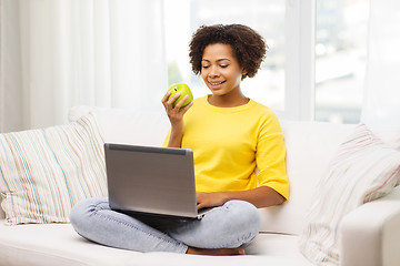 Image showing happy african american woman with laptop at home