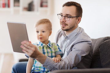 Image showing father and son with tablet pc playing at home