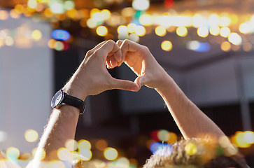 Image showing close up of fan hands showing heart at concert