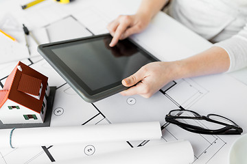 Image showing close up of hand with blueprint and tablet pc