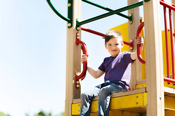 Image showing happy little boy climbing on children playground