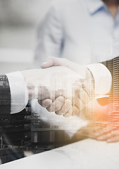 Image showing two businessmen shaking hands in office