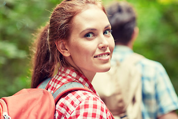 Image showing group of smiling friends with backpacks hiking