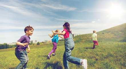 Image showing group of happy kids running outdoors