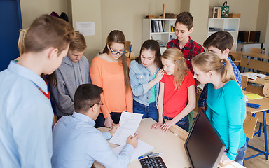 Image showing group of students and teacher with tests at school