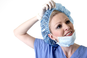 Image showing Lady surgeon removing cap