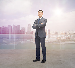 Image showing happy smiling businessman over singapore city 