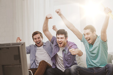 Image showing happy male friends with vuvuzela watching sports