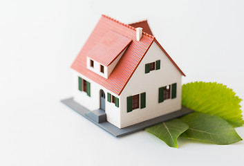 Image showing close up of house model and green leaves