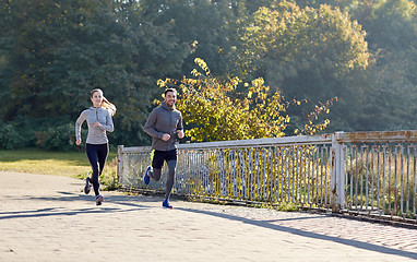 Image showing happy couple running outdoors