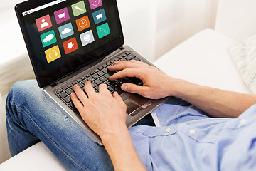 Image showing close up of man typing on laptop computer at home