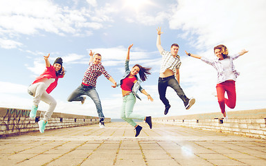 Image showing group of teenagers jumping