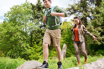 Image showing happy couple with backpacks hiking outdoors