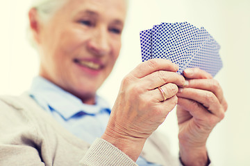 Image showing close up of happy senior woman playing cards