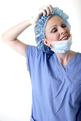 Image showing Surgeon taking off hair net