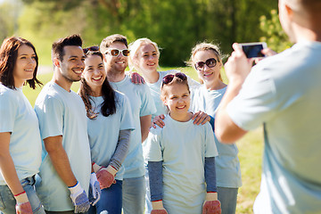 Image showing group of volunteers taking picture by smartphone